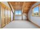 Light-filled bedroom with vaulted wood ceiling, two windows, and closet at 280 Hess Ave, Golden, CO 80401