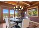 Bright dining area featuring wood beams and views of the surrounding natural landscape at 280 Hess Ave, Golden, CO 80401
