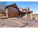 Charming log home with a spacious two-car garage and covered porch entrance at 280 Hess Ave, Golden, CO 80401