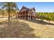 Stunning exterior of a log home with a wraparound porch and well-maintained lawn at 280 Hess Ave, Golden, CO 80401
