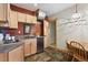 Charming kitchenette featuring light wood cabinets, essential appliances, and adjacent dining area at 280 Hess Ave, Golden, CO 80401