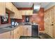 Functional kitchenette with wooden cabinets, compact appliances, and unique slate tile flooring at 280 Hess Ave, Golden, CO 80401