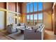 Bright living room with vaulted ceiling, wood beams, and a large window with mountain views at 280 Hess Ave, Golden, CO 80401