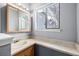 Bathroom with a vanity, a large mirror, modern lighting, and a bright window at 93 S Nome St, Aurora, CO 80012