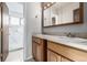 Bathroom with double sinks, wood cabinets, and a tiled shower in the background at 93 S Nome St, Aurora, CO 80012