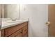 Bathroom featuring a vanity with a sink, mirror, and wood cabinetry at 93 S Nome St, Aurora, CO 80012