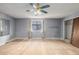 Bedroom with gray walls, a ceiling fan, a window with curtains, and hardwood floors at 93 S Nome St, Aurora, CO 80012