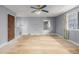 Vacant bedroom with gray walls, ceiling fan, large window, and hardwood floors at 93 S Nome St, Aurora, CO 80012