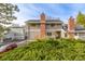 Exterior of townhome with brick chimney and lush landscaping at 93 S Nome St, Aurora, CO 80012