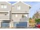 Exterior view of townhome with siding and blue garage doors at 93 S Nome St, Aurora, CO 80012