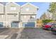 Exterior view of a townhome with blue garage doors at 93 S Nome St, Aurora, CO 80012