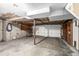 Spacious garage with concrete floors and exposed ceiling at 93 S Nome St, Aurora, CO 80012
