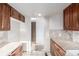 A kitchen area featuring wood cabinets, tile floors, and access to another room at 93 S Nome St, Aurora, CO 80012