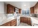 Traditional kitchen with wood cabinets, white appliances, and tile backsplash at 93 S Nome St, Aurora, CO 80012