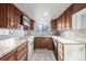 Traditional kitchen featuring wooden cabinets, tile countertops, and bright natural light at 93 S Nome St, Aurora, CO 80012