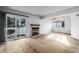 Spacious living room featuring a fireplace, sliding glass door, and ample sunlight at 93 S Nome St, Aurora, CO 80012