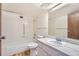 All-white bathroom with tiled tub, shower, and bright vanity sink at 14152 E Linvale Pl # 509, Aurora, CO 80014