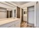 Bathroom vanity with mirrored closet doors for extra space and light at 14152 E Linvale Pl # 509, Aurora, CO 80014