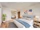 Comfortable bedroom featuring modern decor, wood floors, and a large mirror at 14152 E Linvale Pl # 509, Aurora, CO 80014