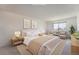 Bright bedroom with neutral walls, carpeted floors, and comfortable seating area by the window at 14152 E Linvale Pl # 509, Aurora, CO 80014