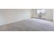 Empty bedroom with neutral carpet and bright window to the exterior at 14152 E Linvale Pl # 509, Aurora, CO 80014