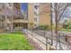 Inviting building entrance featuring a ramp, mature trees, and manicured landscaping for enhanced accessibility at 14152 E Linvale Pl # 509, Aurora, CO 80014