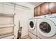Convenient laundry room with washer, dryer, storage, and shelving at 14152 E Linvale Pl # 509, Aurora, CO 80014