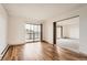 Spacious living room showcasing hard wood floors and a large sliding glass door at 14152 E Linvale Pl # 509, Aurora, CO 80014