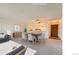 Bright living room with kitchen view and dining area, featuring neutral colors and plenty of natural light at 14152 E Linvale Pl # 509, Aurora, CO 80014