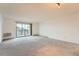 Bright living room featuring a sliding door to the balcony area, and natural light at 14152 E Linvale Pl # 509, Aurora, CO 80014