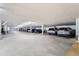 Well-lit parking garage offering ample spaces for residents and guests under a solid ceiling structure at 14152 E Linvale Pl # 509, Aurora, CO 80014