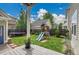 Spacious backyard with a playground, trampoline, and green lawn at 3212 Fulton St, Denver, CO 80238