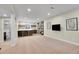 Finished basement offers open living space with a bar area, custom cabinetry, and an adjacent bathroom at 3212 Fulton St, Denver, CO 80238