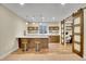 Basement bar area with sleek counter seating, custom cabinets and convenient access to a work-from-home office at 3212 Fulton St, Denver, CO 80238