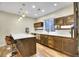 Basement kitchen area featuring a center island, stainless steel appliances, and ample counter space at 3212 Fulton St, Denver, CO 80238