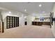 Finished basement features an open floor plan, custom shelving, and a stylish bar area at 3212 Fulton St, Denver, CO 80238