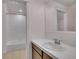 Bathroom with a white tiled shower-tub, vanity and ample mirror providing a clean and functional space at 3212 Fulton St, Denver, CO 80238
