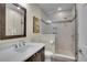 Modern bathroom featuring walk-in shower, new vanity, and stylish tile at 3212 Fulton St, Denver, CO 80238