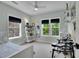 Bright bedroom with two windows, a ceiling fan, and a drumset, providing ample space for work and play at 3212 Fulton St, Denver, CO 80238