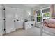 Charming bedroom with carpet, featuring a lofted bed, large windows, and ample storage with white furnishings at 3212 Fulton St, Denver, CO 80238