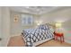 Bright bedroom features stylish bedding, window with shutters, and a ceiling fan at 3212 Fulton St, Denver, CO 80238