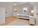 Sunlit bedroom with hardwood floors, a plush rug, and a cozy single bed next to a window at 3212 Fulton St, Denver, CO 80238
