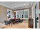 Bright breakfast nook with built-in seating, round table, and many windows overlooking the backyard at 3212 Fulton St, Denver, CO 80238