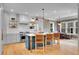 Stylish kitchen featuring a large center island with seating, stainless steel appliances, and modern pendant lighting at 3212 Fulton St, Denver, CO 80238