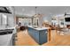 Spacious kitchen with large island, stainless appliances, breakfast nook, hardwood floors, and plenty of natural light at 3212 Fulton St, Denver, CO 80238