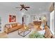Open-concept living room and kitchen with hardwood floors, plenty of seating, and bright natural light at 3212 Fulton St, Denver, CO 80238