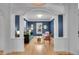 Inviting living room with blue accent wall, white trim, hardwood floors, and ample natural light at 3212 Fulton St, Denver, CO 80238