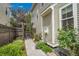 Side yard featuring walkway, garden beds, wooden gate, and lush greenery at 3212 Fulton St, Denver, CO 80238
