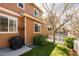 Exterior view of a home with a well-maintained yard, a barbecue grill, and a white picket fence at 3567 E 140Th Dr, Thornton, CO 80602