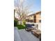 Backyard patio featuring modern outdoor seating surrounded by lush greenery and a charming white picket fence at 3567 E 140Th Dr, Thornton, CO 80602